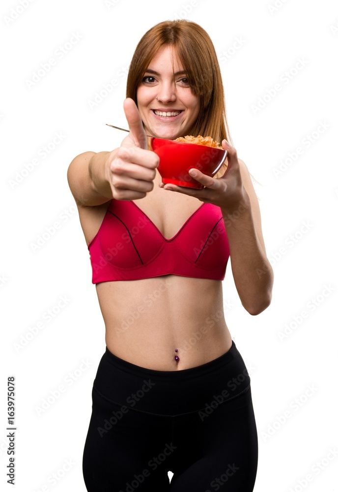 Young sport woman eating cereals from a bowl Young sport woman eating cereals from a bowl