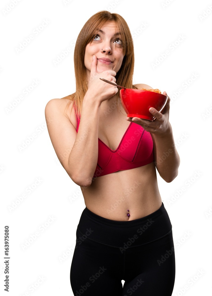 Young sport woman eating cereals from a bowl Young sport woman eating cereals from a bowl