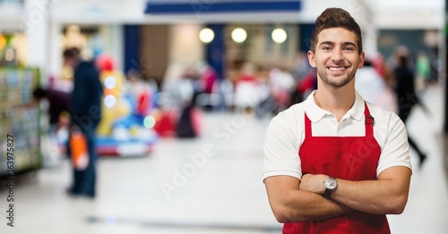 Shop owner arms crossed against blurry shops