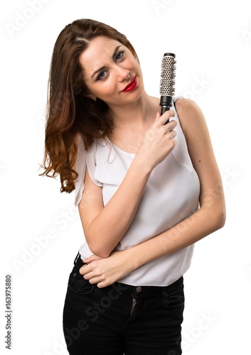 Beautiful young girl with hair comb