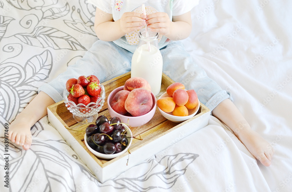 Little Girl Eating Breakfast at Home Milk Berries Peaches Apricots Cherry Strawberry Yogurt Diet Vitamins Summer Concept of Healthy Food for Children