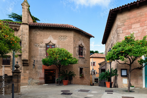 Traditional medieval square with citrus trees in Spanish village (Poble Espanyol) at Barcelona town, Catalonia, Spain