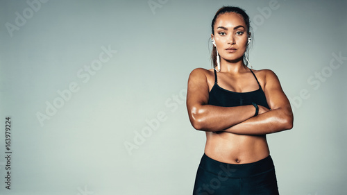 Fitness woman standing confidently
