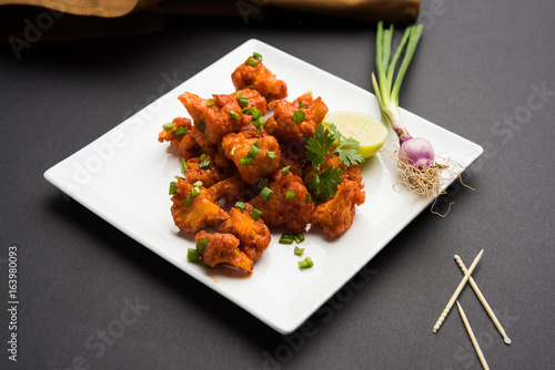 Gobi Manchurian dry - Popular street food of India made of cauliflower florets, selective focus
 photo