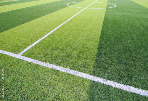 Photo of a green synthetic grass sports field with white line shot from above