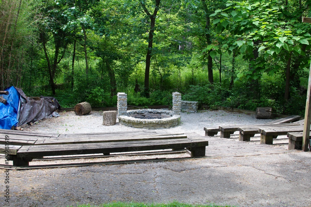 The wood benches by the fire pit in the park.