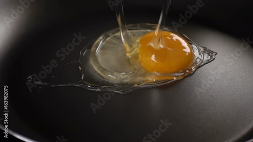 The egg falls on a hot frying pan