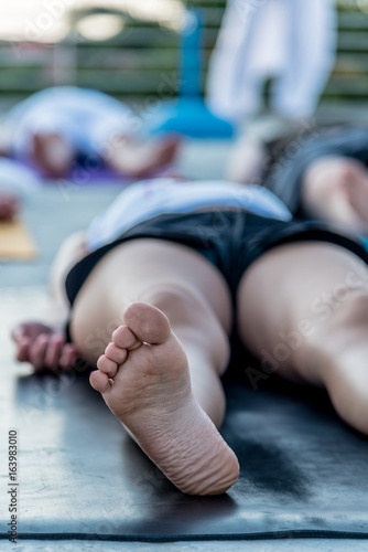 Принти на полотні Woman lying in corpse pose relaxing after yoga class