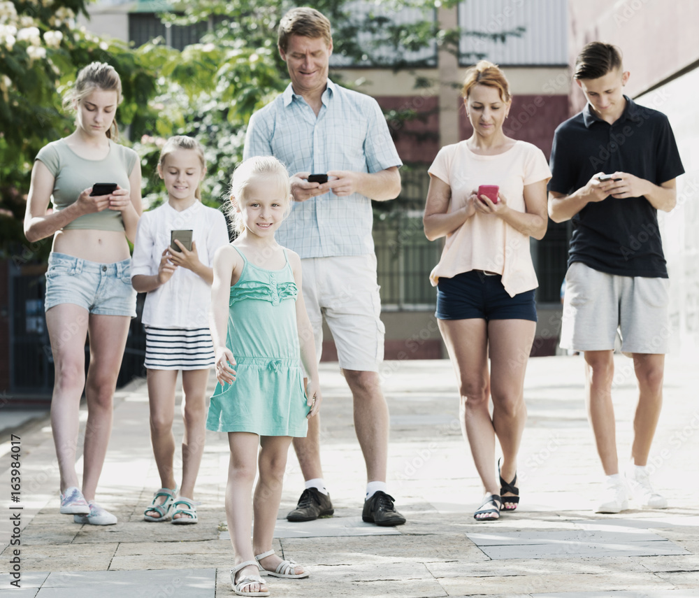 Young family with children looking at phone