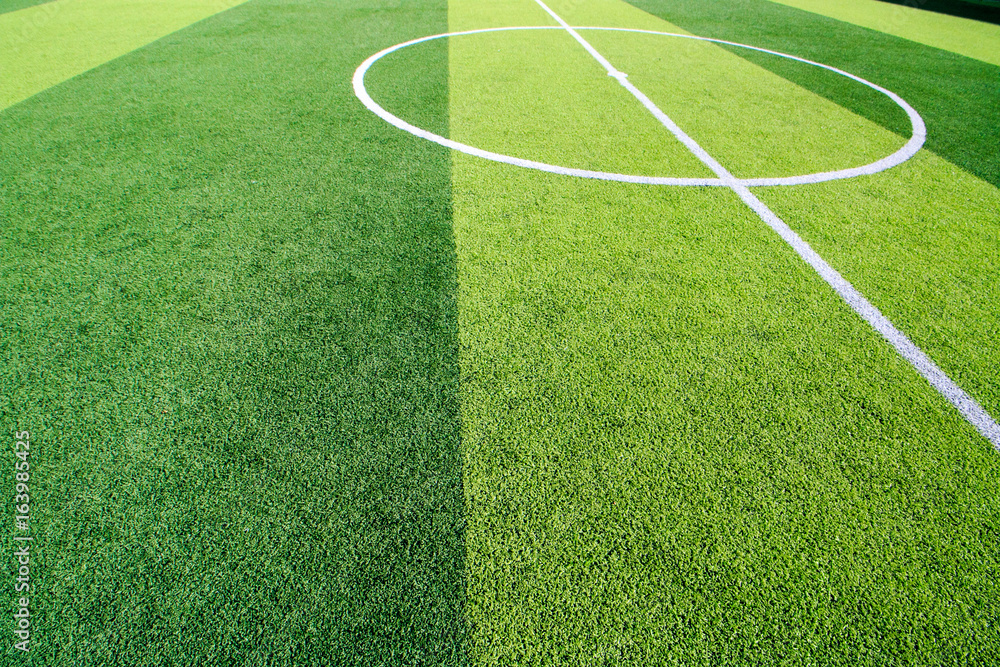 Obraz premium The white Line marking on the artificial green grass soccer field