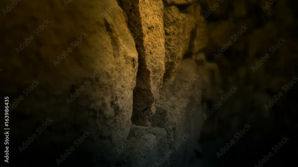 nostalgic stone wall with golden lights at night. nostalgic stone wall with golden lights at night.
