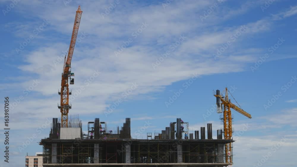 4k video of Crane moving construction panel with blue sky 4k video of Crane moving construction panel with blue sky
