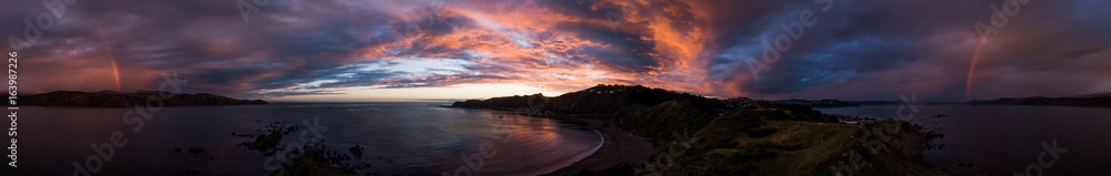 aerial panorama sunset rainbows and cloud formations, breaker bay, new zealand