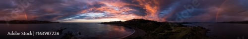 aerial panorama sunset rainbows and cloud formations, breaker bay, new zealand