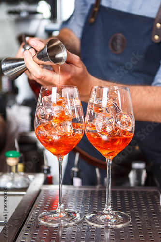 Barman at work, preparing cocktails. concept about service and beverages