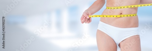 Slim healthy woman holding measuring tape