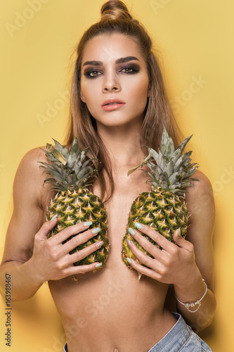 Young crazy girl with pineapples.