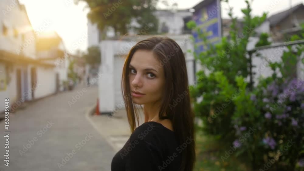 Close-up portrait of beautiful caucasian woman with charming smile walking outdoors Close-up portrait of beautiful caucasian woman with charming smile walking outdoors