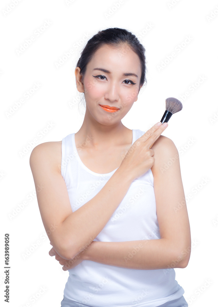 Portrait of the beautiful woman with makeup brushes near face Portrait of the beautiful woman with makeup brushes near face