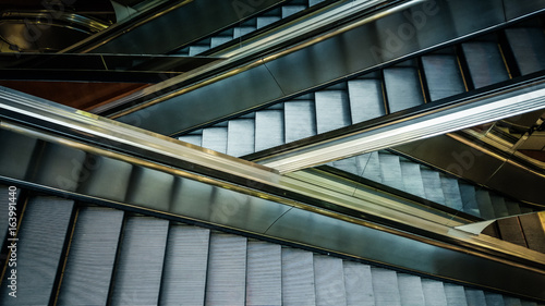 Modern interior design  modern escalators  chrome escalators. Black and White   monochrome  abstract artistic view. Modern art. Steel design. Architecture.