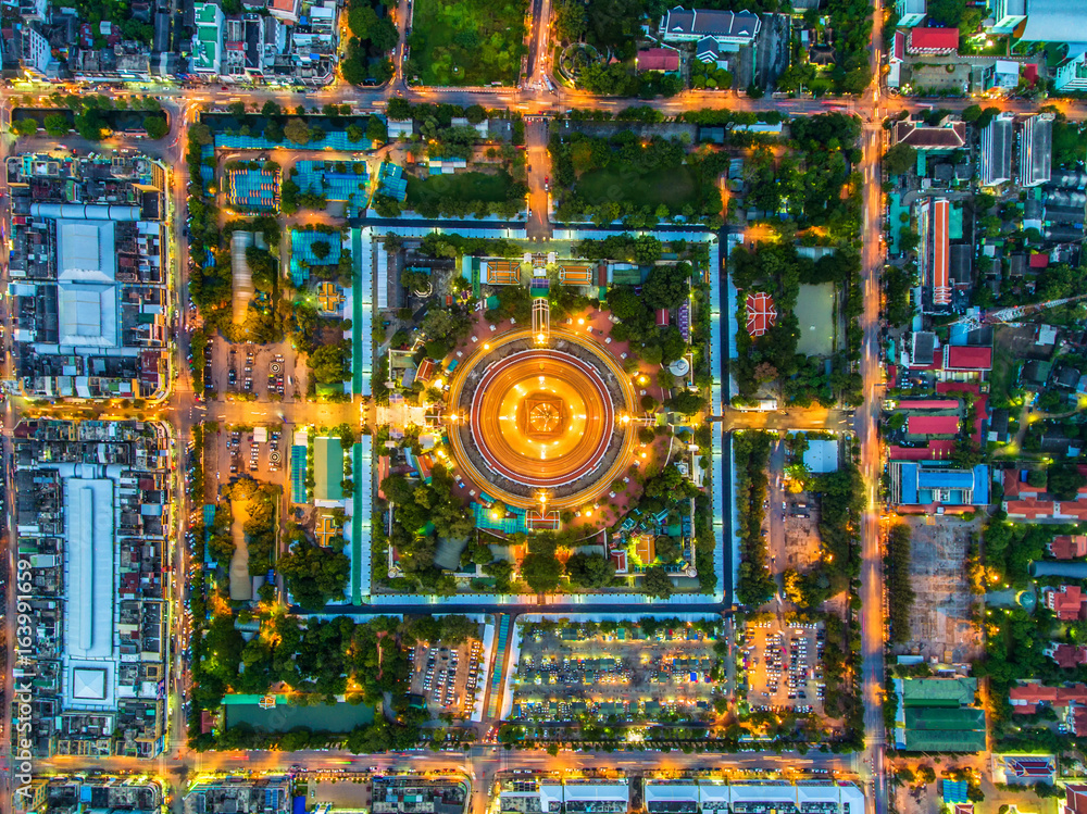 Aerial view Road roundabout with car lots in Thailand.Beautiful street.The light on the road at night and the city in Thailand.Lights of cars on the road.Phra Pathom Chedi.