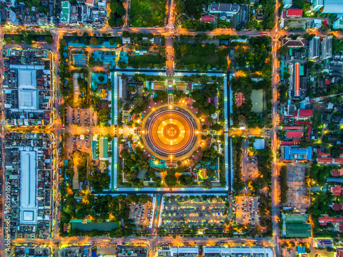 Aerial view Road roundabout with car lots in Thailand.Beautiful street.The light on the road at night and the city in Thailand.Lights of cars on the road.Phra Pathom Chedi.