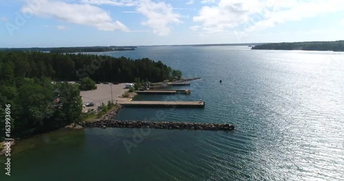 Nauvo, Cinema 4k aerial view towards Nagu parnas ferry terminal to korppoo, on a sunny summer day, in the finnish archipelago of Turku, Varsinais-suomi, Finland photo