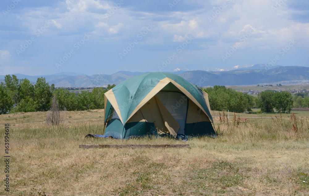 Camping in tent at Standley Lake Regional Park in Westminster Colorado with view of Rocky Mountains