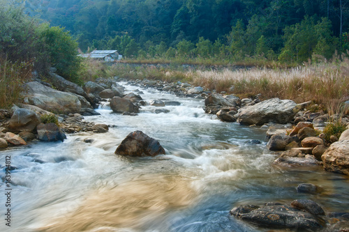 River water flowing through rocks at dawn