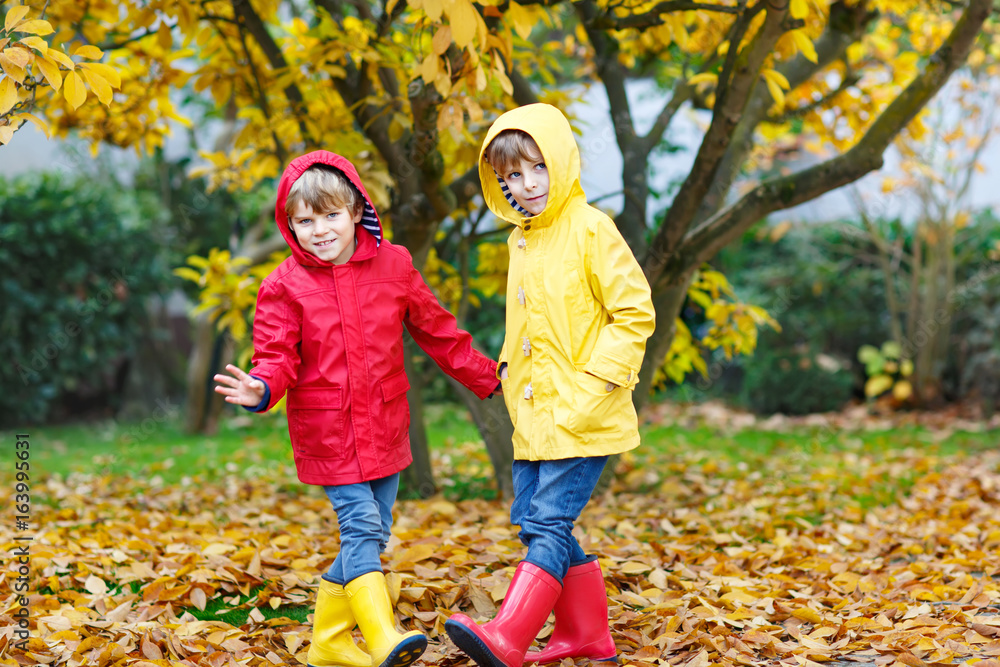 Two little best friends and kids boys autumn park in colorful clothes. Two little best friends and kids boys autumn park in colorful clothes.
