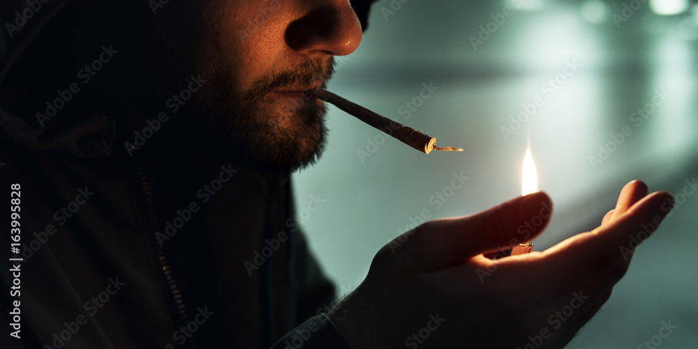 Fototapeta premium Homeless Adult Man Lightening Up Cigarette Addiction