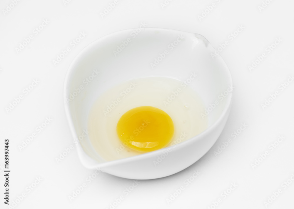 Closeup of fresh organic egg yolk in cup Closeup of fresh organic egg yolk in cup