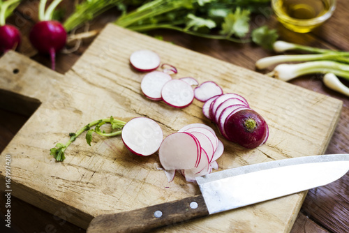 Closeup of fresh radish on wooden cut board