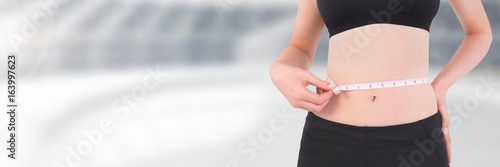 Slim healthy woman holding measuring tape
