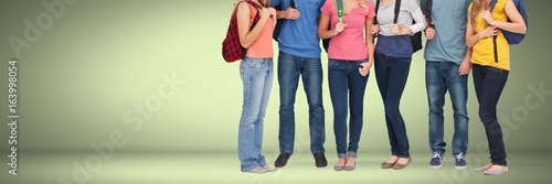 Group of colorful students standing with bags and green vignette
