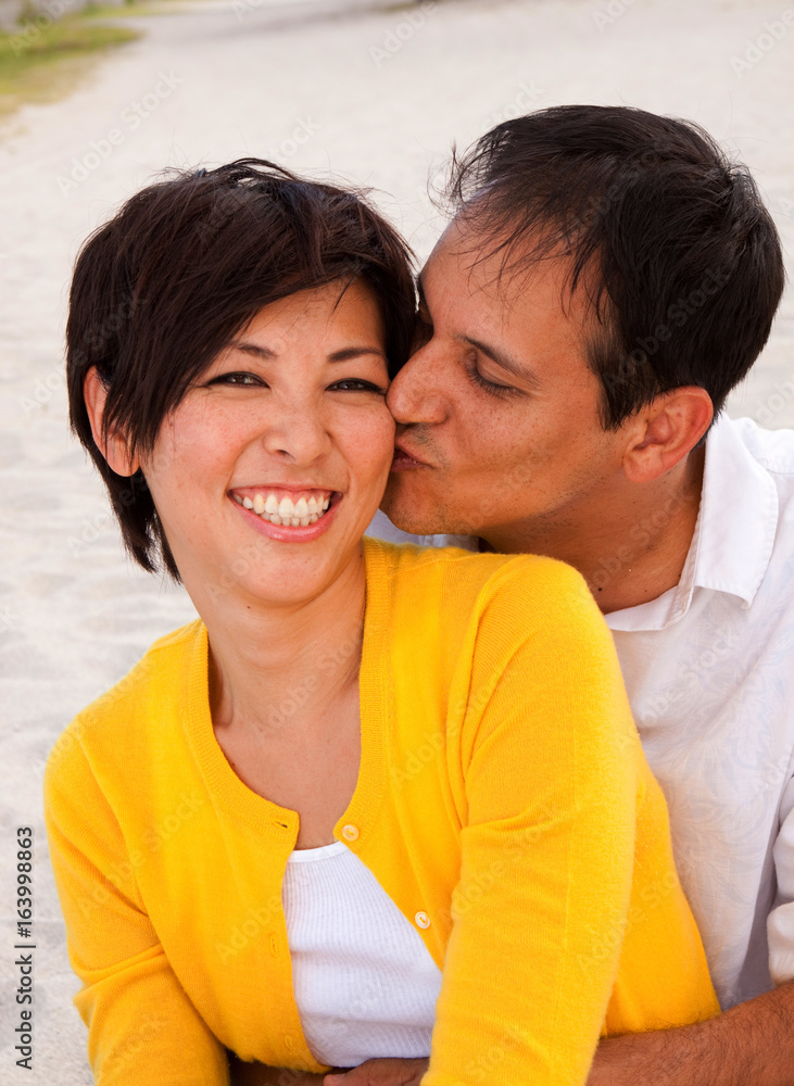 Happy couple laughing and talking at the beach. Happy couple laughing and talking at the beach.