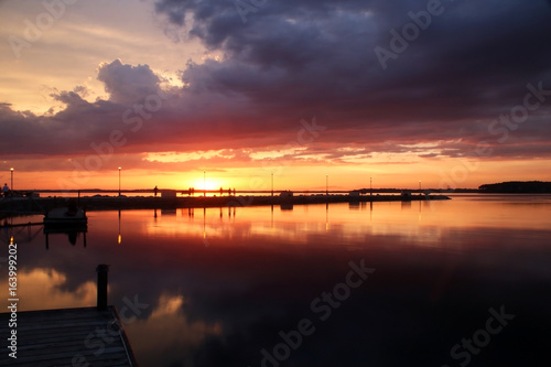 Summer sunset over the lake. Beautiful landscape with golden sunset after evening storm on a lake Mendota in the city of Madison, Wisconsin, USA. Long exposure horizontal shot.