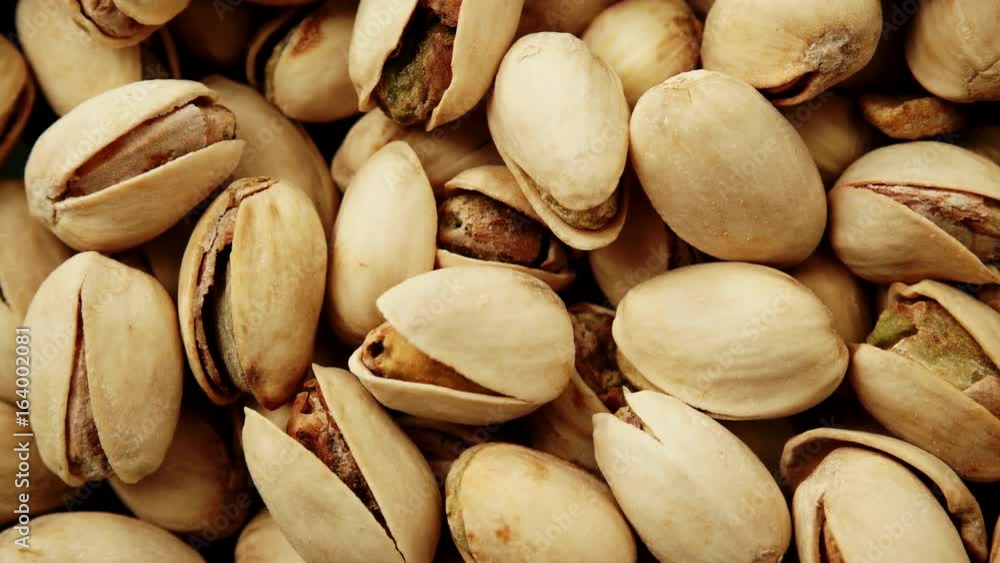Food background. Roasted pistachio nuts seed with shell close up. Dieting concept. Dolly slider shot 4K ProRes HQ codec Food background. Roasted pistachio nuts seed with shell close up. Dieting concept. Dolly slider shot 4K ProRes HQ codec