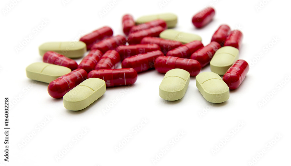 Green and red pills on a white background. Green and red pills on a white background.