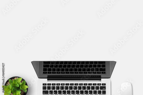 Modern workplace with notebook and little tree copy space on gray background. Top view. Flat lay style.