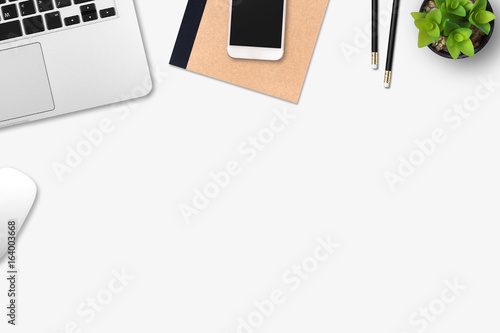 Modern workplace with notebook, smartphone, tree and pencil copy space on gray background. Top view. Flat lay style.