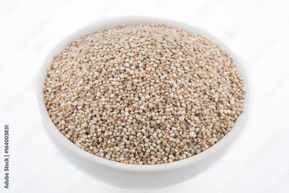 Chenopodium quinoa Seeds in a Bowl. Raw quinoa seeds in a bowl from above,on white background.. Chenopodium quinoa Seeds in a Bowl. Raw quinoa seeds in a bowl from above,on white background..