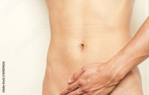Men's hands touch the abdomen of women