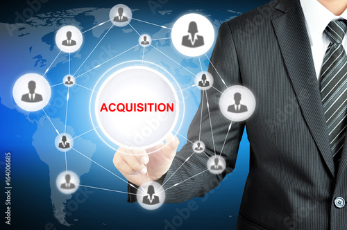 Hand pointing to ACQUISITION sign with businesspeople icon network on virtual screen