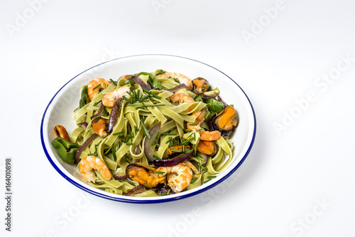 Green tagliatelle with seafood. Mussels; Prawns. Isolated