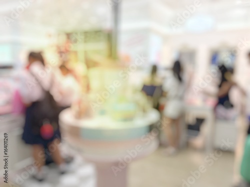 blurred image of shopping mall and people or Businesswoman in Beauty Shop.