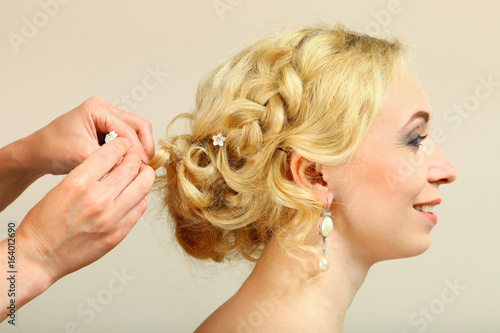 A hairdresser does a hairstyle