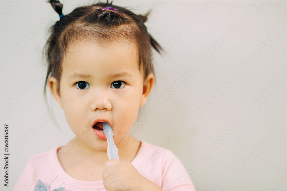1 year 9 months baby brushing her teeth. Dental care activity for tooth & gums : Selective focus. 1 year 9 months baby brushing her teeth. Dental care activity for tooth & gums : Selective focus.