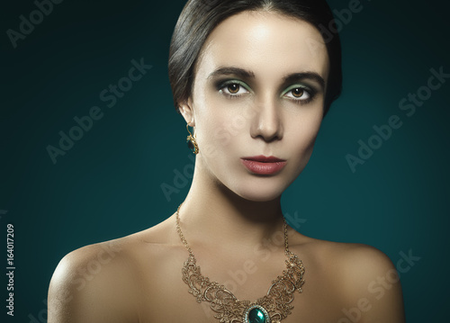 Studio portrait of a beautiful young woman with necklace