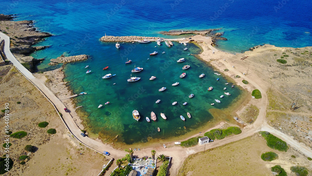 Aerial drone photo of small and safe bay of Parianos with docked fishing boats, Koufonissi island, small Cyclades, Aegean, Greece